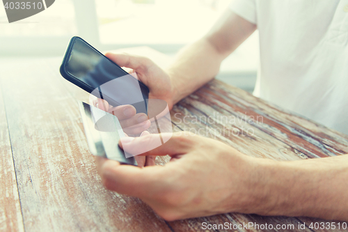 Image of close up of hands with smart phone and credit card