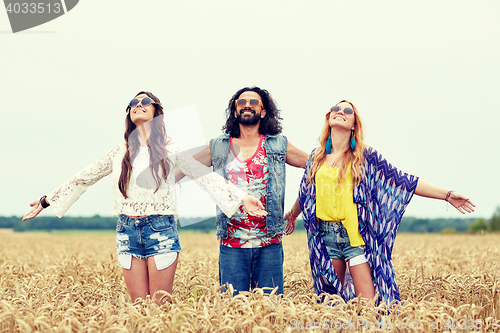 Image of smiling young hippie friends on cereal field