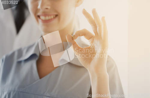Image of close up of doctor or nurse showing ok sign