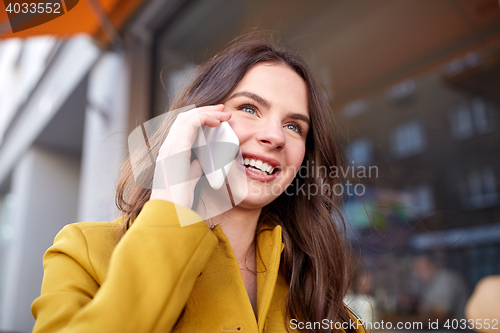 Image of smiling young woman or girl calling on smartphone
