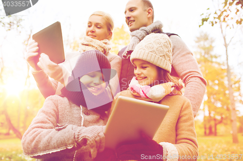 Image of happy family with tablet pc in autumn park