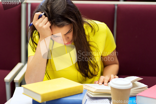 Image of student girl with books and coffee on lecture