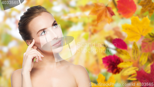 Image of beautiful young woman touching her face