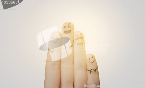 Image of close up of hands and fingers with smiley faces