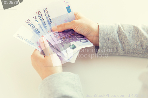 Image of close up of woman hands counting euro money