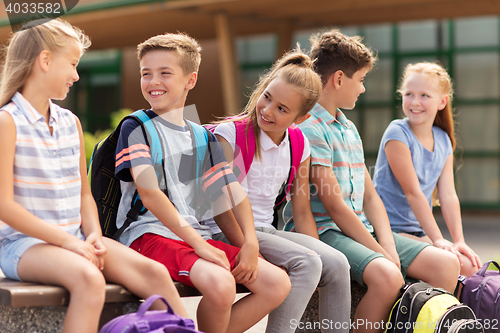 Image of group of happy elementary school students talking