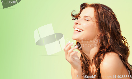 Image of happy woman over green natural background