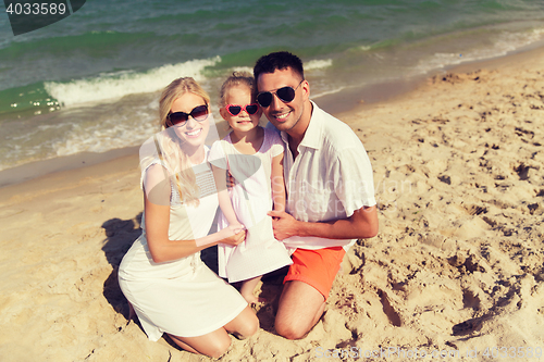 Image of happy family in sunglasses on summer beach