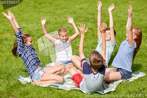 Image of group of happy kids or friends outdoors