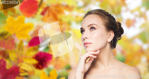 Image of beautiful young woman touching her face