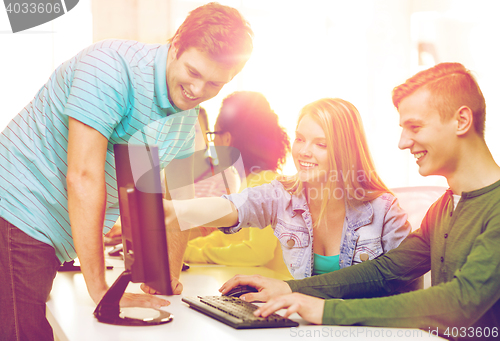 Image of smiling students in computer class at school