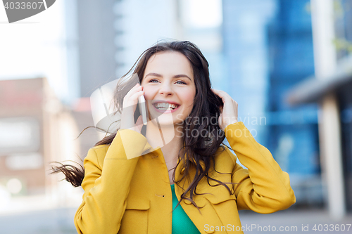 Image of smiling young woman or girl calling on smartphone