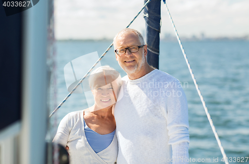 Image of senior couple hugging on sail boat or yacht in sea