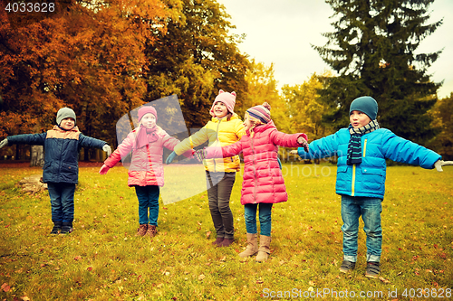 Image of happy little children running and playing outdoors