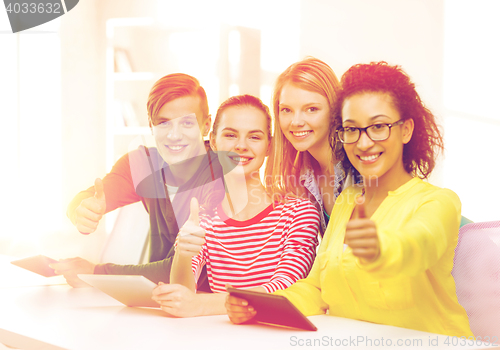 Image of smiling students with tablet pc at school