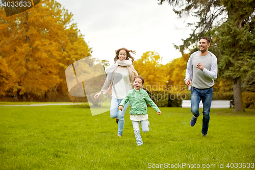 Image of happy family walking in summer park