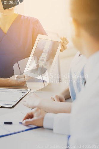 Image of close up of happy doctors with x-ray at hospital