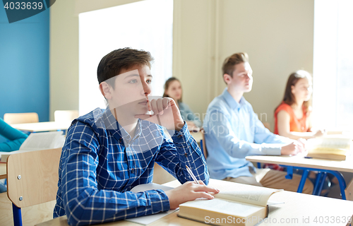 Image of happy student boy at school lesson