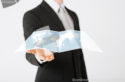 Image of close up of businessman showing world map