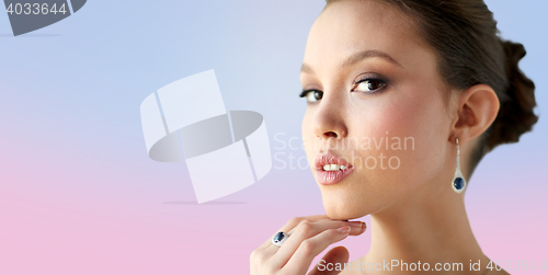 Image of beautiful woman with earring and finger ring