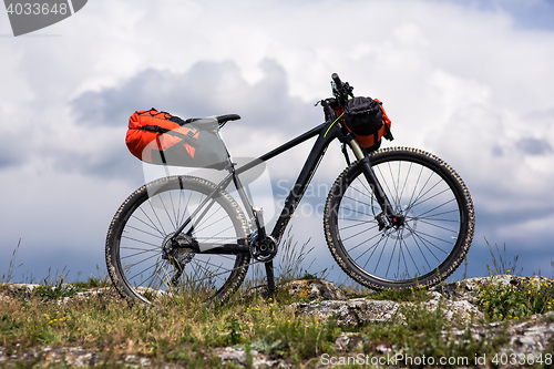 Image of Bicycle with orange bags for travel