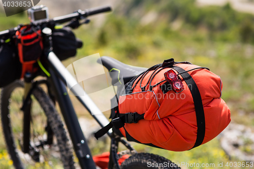 Image of Bicycle with orange bags for travel