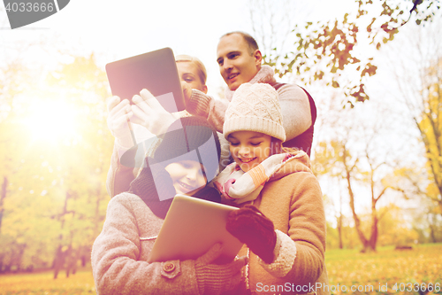 Image of happy family with tablet pc in autumn park