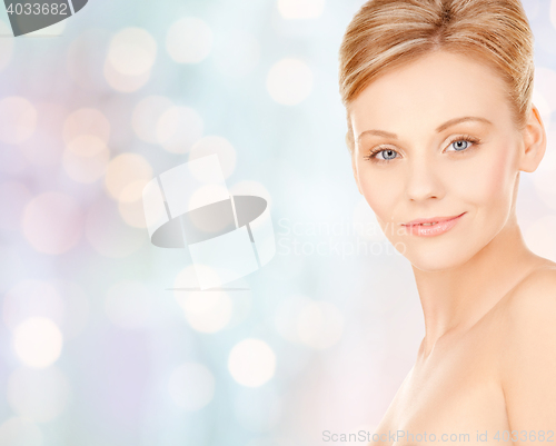 Image of beautiful young woman face over blue background