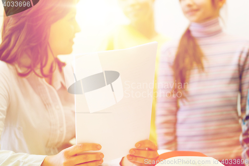 Image of close up of school kids with teacher in classroom