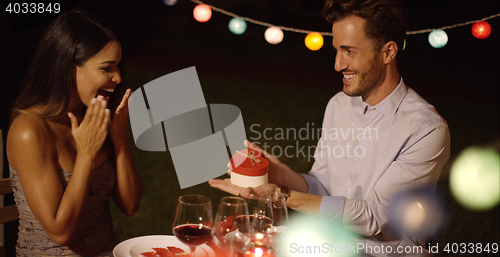 Image of Romantic young man presenting a Valentines gift