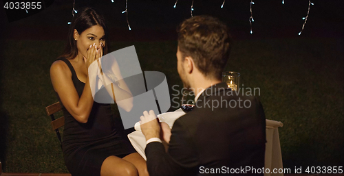 Image of Young man proposing to a gorgeous  woman