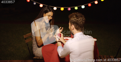 Image of Young man down on his knees proposing