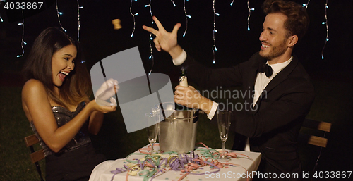 Image of Man in suit and bow tie celebrates with date