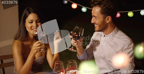 Image of Romantic young couple enjoying dinner and wine