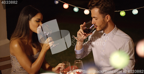 Image of Romantic young couple enjoying dinner and wine
