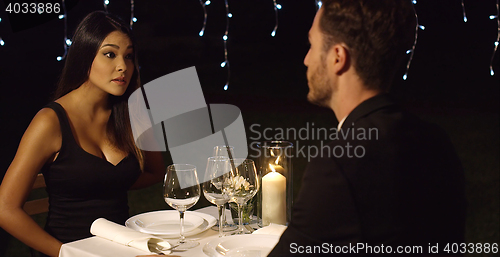 Image of Surprised woman looks questioningly at husband