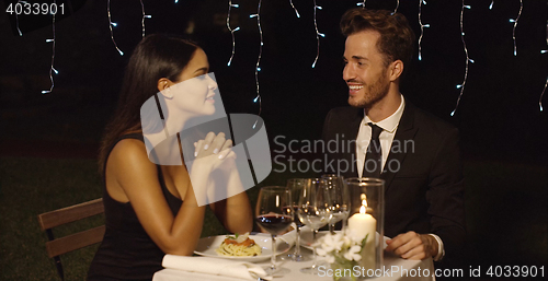 Image of Handsome couple laughing while at restaurant