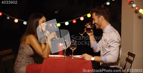 Image of Good looking couple toasts with glasses of wine