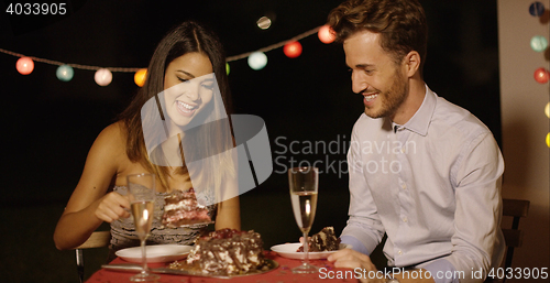 Image of Playful man looking with anticipation at cake