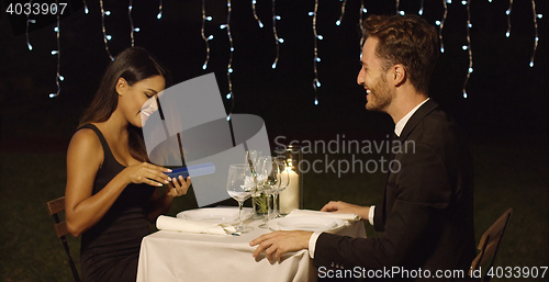 Image of Gorgeous young woman opening a gift