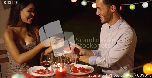 Image of Romantic young man presenting a Valentines gift