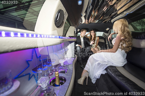Image of Celebrities in a luxurious limousine