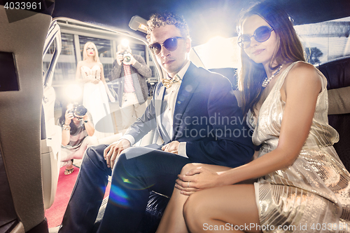 Image of Celebrity couple in a limousine