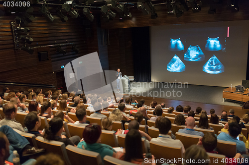 Image of Business speaker giving a talk in conference hall.