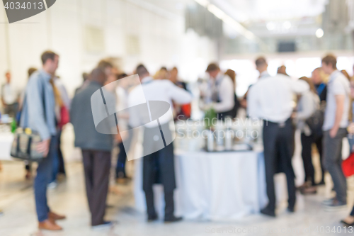 Image of Abstract blurred people socializing during coffee break at business conference.