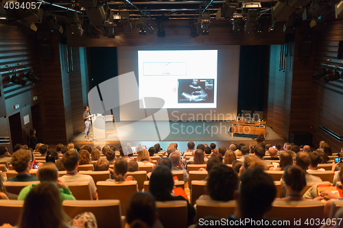 Image of Business speaker giving a talk in conference hall.