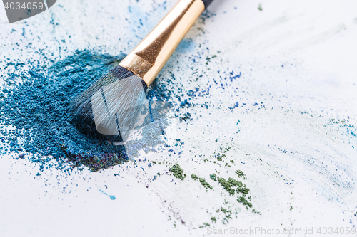 Image of Crisp blue eye shadow with brush on white background
