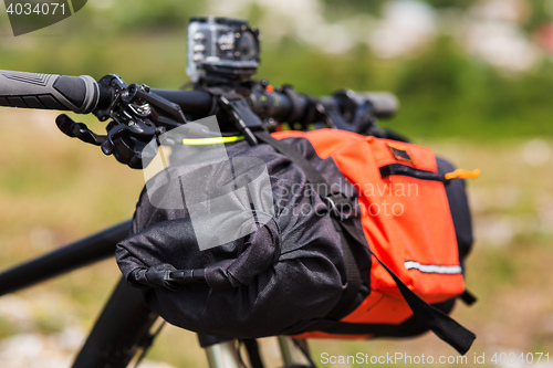 Image of Bicycle with orange bags for travel