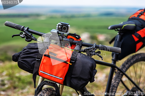 Image of Bicycle with orange bags for travel