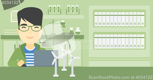 Image of Man working with model wind turbines on the table.